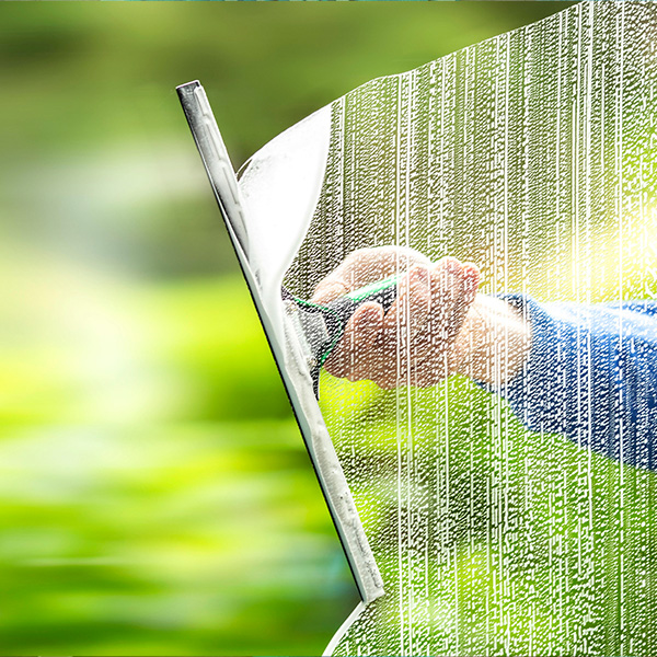 man with squeegee-cleans-window