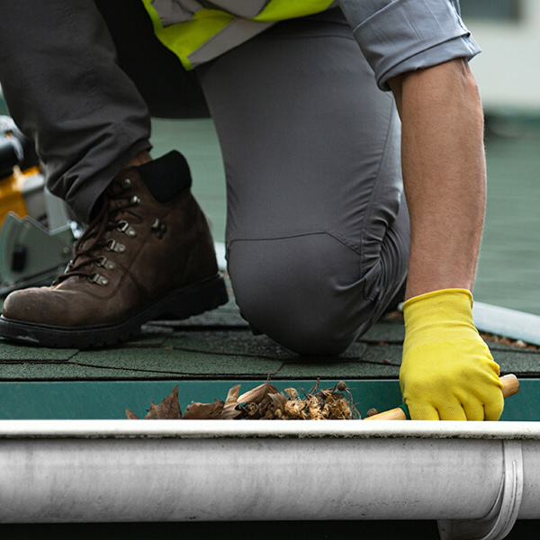 man-worker-is-cleaning-clogged-roof-gutter-from-dirt_1x1